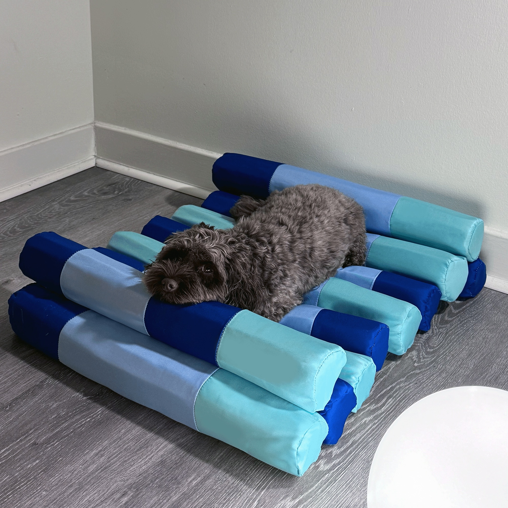 The dog stretched out on the bed