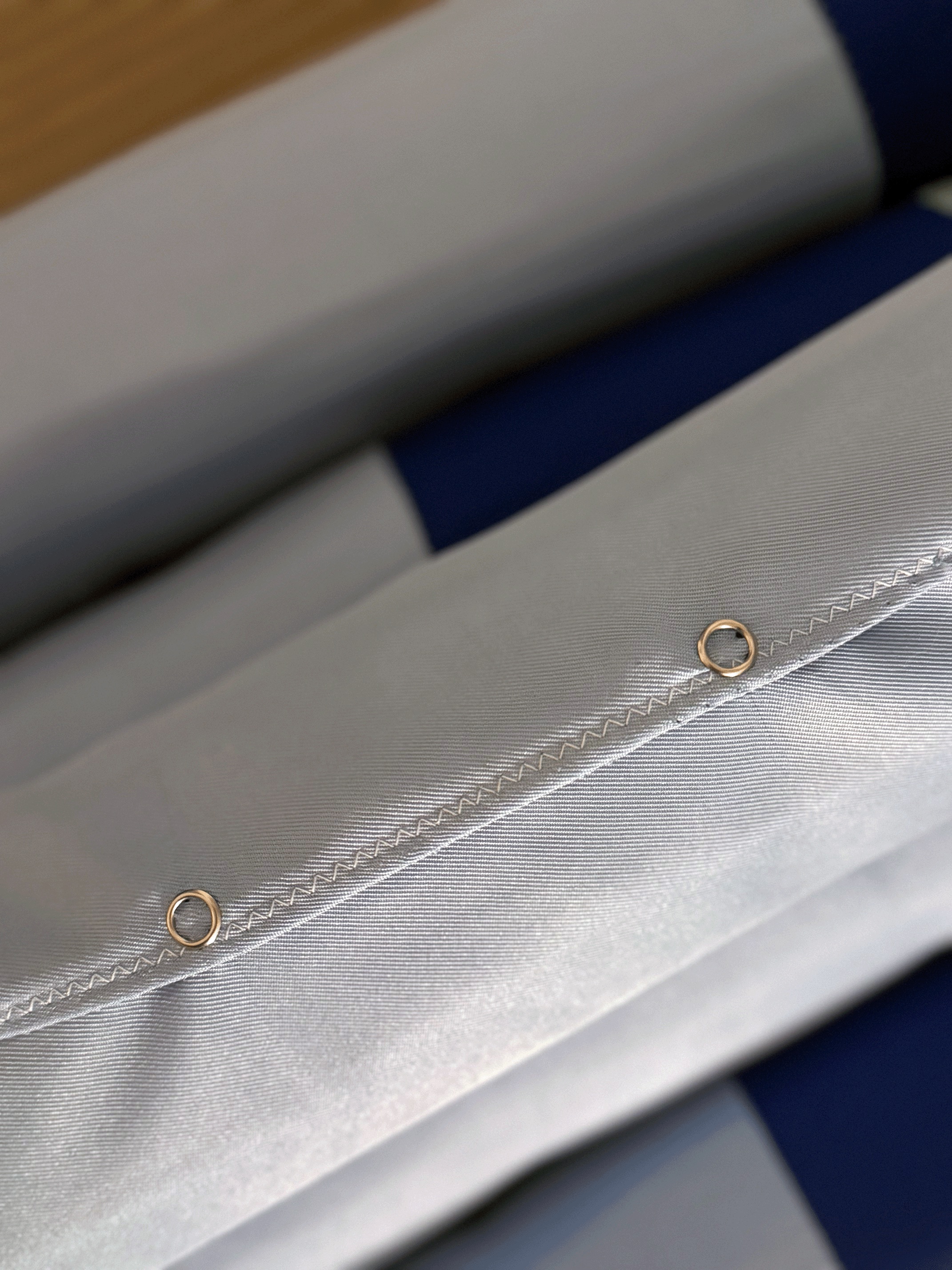 Close-up of the fabric edge and its metal eyelets